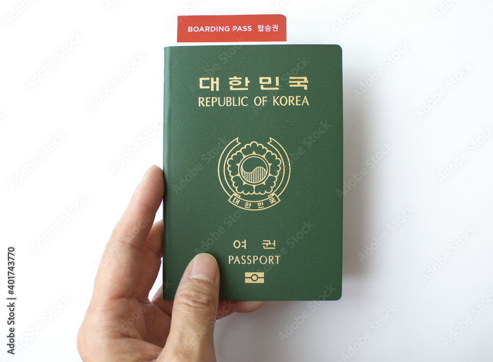 Republic of Korea passport and woman's hand with boarding pass isolated white background. Republic of Korea passport and woman's hand with boarding pass isolated white background.