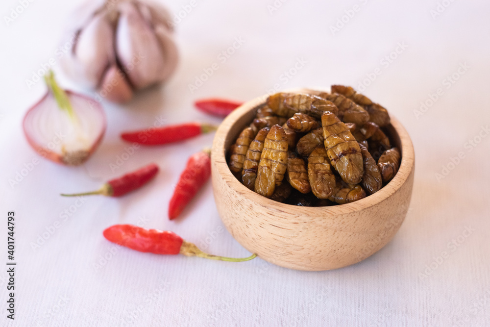 silkworm pupa in wooden bow as edible insects on white background, high protein insect
silkworm pupa in wooden bow as edible insects on white background, high protein insect