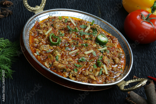 keema matar famous Pakistani North Indian food beef minced Black background garnished with ginger chilly decorated with spices and vegetable 