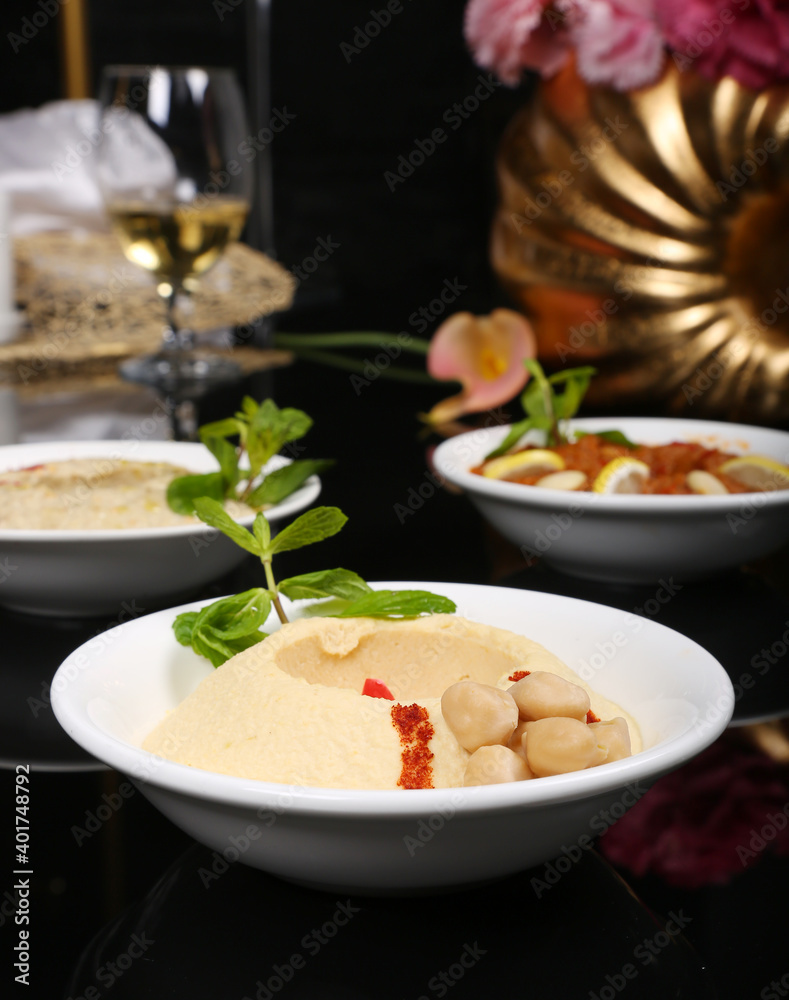 Arabic Turkish starter appetizer humus chickpeas eggplant black background 