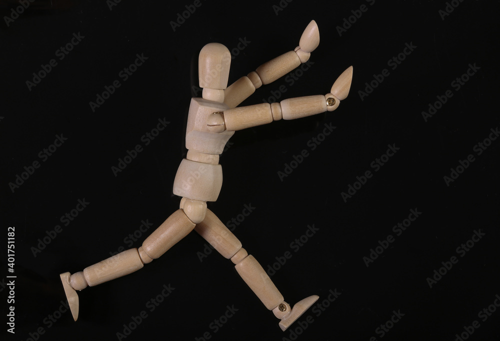 Wooden puppet mannequin isolated on black background Wooden puppet mannequin isolated on black background