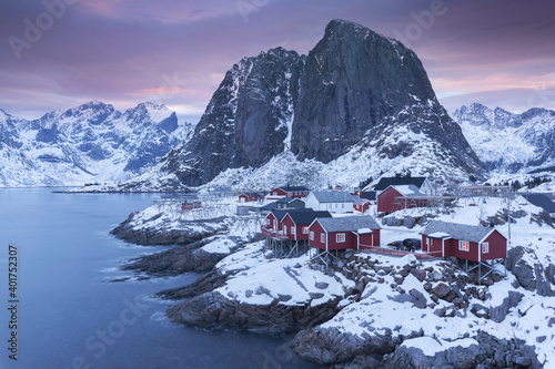 Hamnoy , Lofoten, Norway. Fisherman's Village with snow and red houses photo