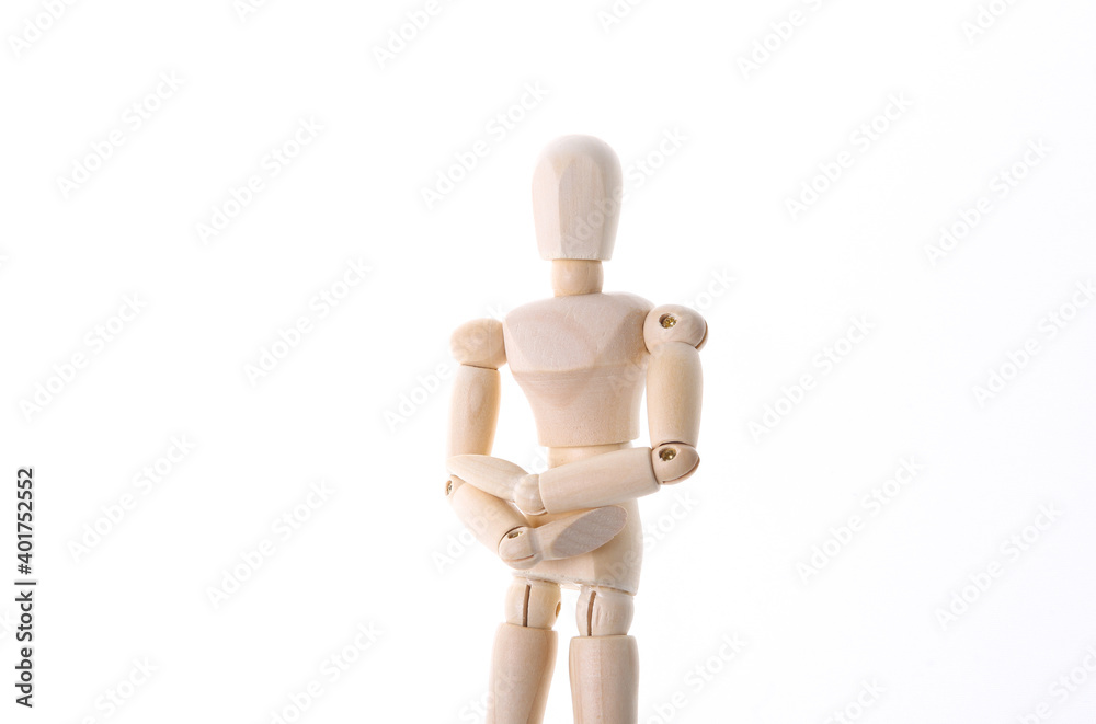 Wooden puppet with stomach pain isolated on white background. Wooden puppet with stomach pain isolated on white background.