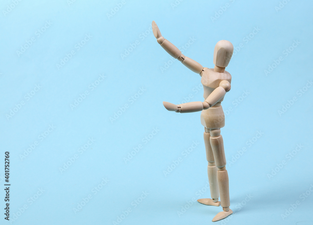 Wooden puppet isolated on blue background Wooden puppet isolated on blue background