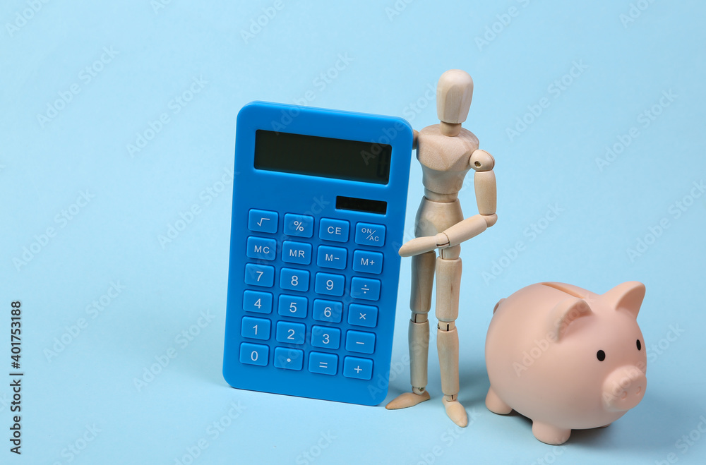 Wooden puppet with calculator and piggy bank on blue background. Costing, save money, economics Wooden puppet with calculator and piggy bank on blue background. Costing, save money, economics