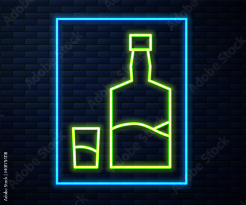 Glowing neon line Tequila bottle and shot glass icon isolated on brick wall background. Mexican alcohol drink. Vector.