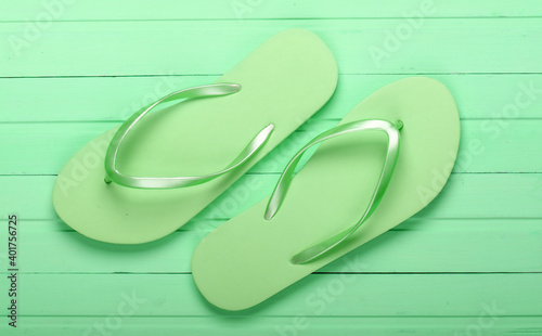 Flip Flops on a green wooden background. Top view