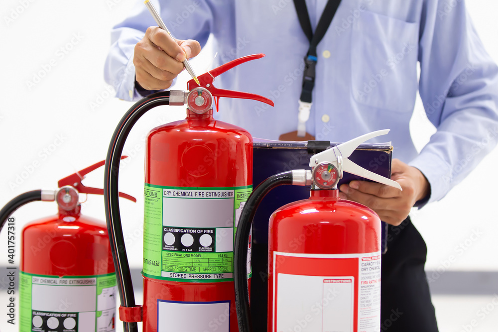 Fire engineering checking pressure gauge level of fire extinguishers ...