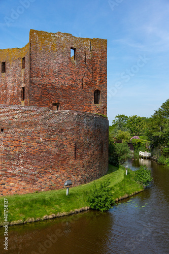 Southside with the moat of the ruin castle Teylingen in the south-holland village of Sassenheim in the Netherlands.