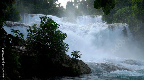 Cascade of Aliwagwag Falls in green forest. Waterfall in the tropical mountain jungle. Philippines, Mindanao. photo