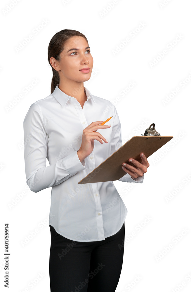 Businesswoman in white shirt thinking standing with clipboard isolated over white background. Young female manager thinking, holding a pencil Businesswoman in white shirt thinking standing with clipboard isolated over white background. Young female manager thinking, holding a pencil