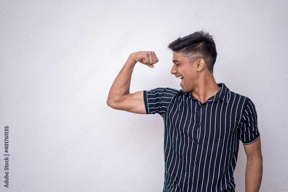 handsome attractive man in half shirt smiling and showing is bicep isolated on a white background. healthy concept handsome attractive man in half shirt smiling and showing is bicep isolated on a white background. healthy concept
