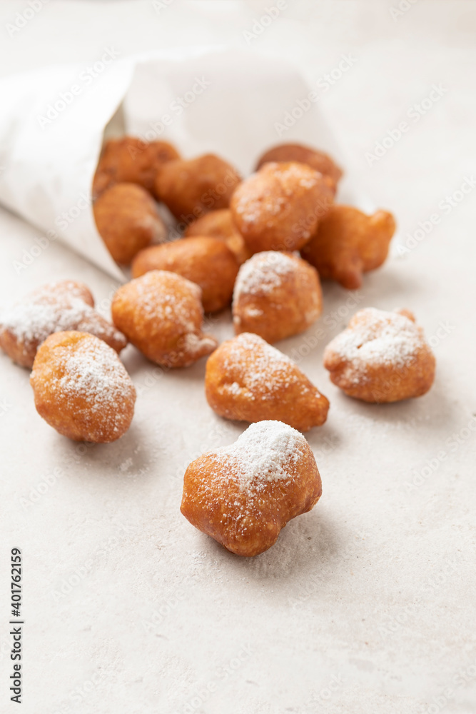 Fried beignets in a typically cornet paper, carnival food in low lands. Fried beignets in a typically cornet paper, carnival food in low lands.