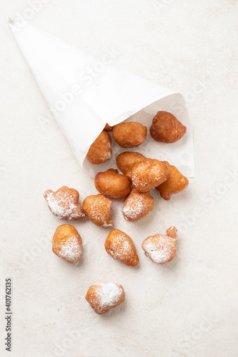 Fried beignets in a typically cornet paper, carnival food in low lands.