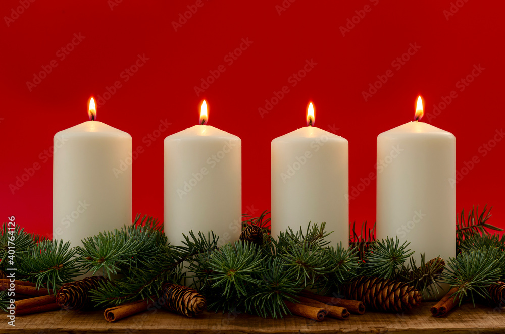 White christmas candles on red background, Advent. 4 burning candles.