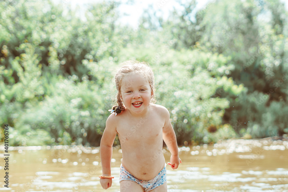 child playing in the river child playing in the river