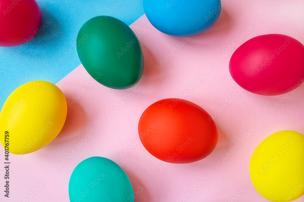 colorful easter eggs on pink background with copy space. Easter background