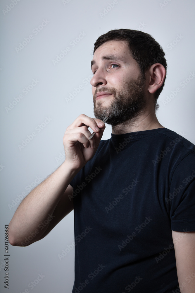 man with the problem of graying beard Plucking Hair with Tweezers from his beard man with the problem of graying beard Plucking Hair with Tweezers from his beard