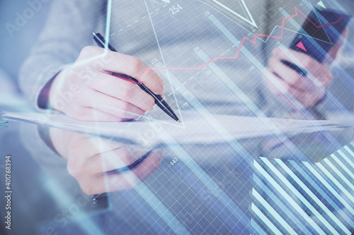 Double exposure of forex chart sketch hologram and woman holding and using a mobile device. Financial market concept.