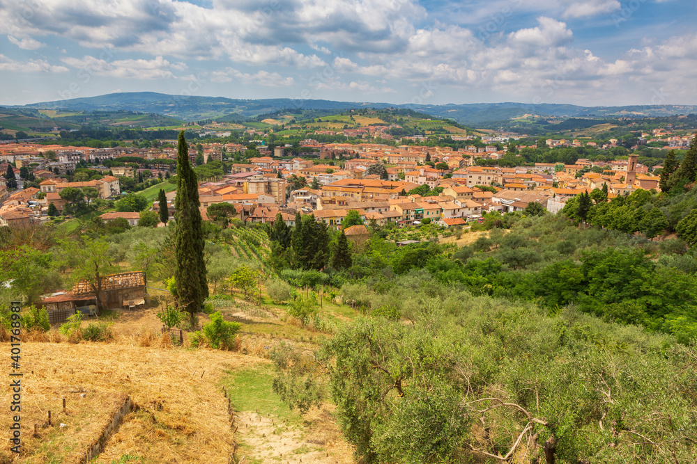 The view from the medevil town of Certaldo that rests high above a mountain surrounded by an olive grove that overlooks the modern version of the small town located in the heart of Tuscany, Italy. 