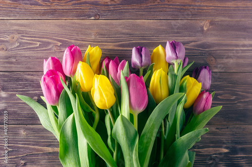 Colorful tulips on a wooden background