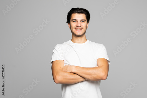 Portrait of a young man with crossed hands isolated on white background