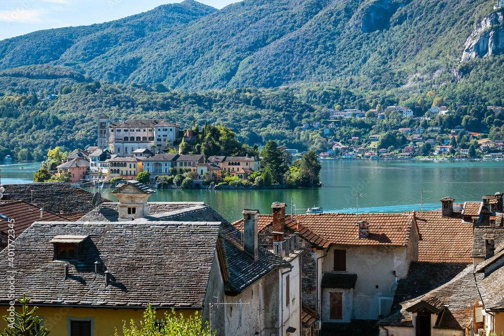 The world famous Orta San Giulio island, in the Orta Lake (piedmont, Northern Italy) seen from the city of Orta, along the lake shores. It is UNESCO World Heritage Site.