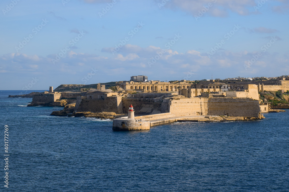 Lighthouse in front of old ruins in Malta