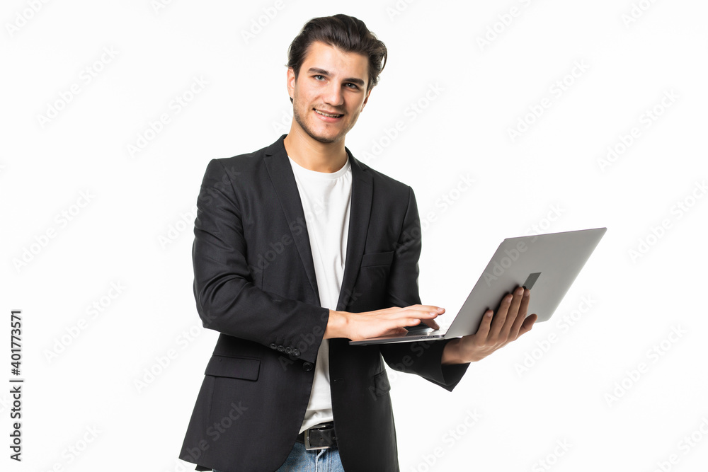 Concentrated on work. Confident young handsome man in shirt and tie working on laptop while standing against white background Concentrated on work. Confident young handsome man in shirt and tie working on laptop while standing against white background
