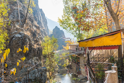 Outdoor restaurant next to a creek with big umbrellas Darband valley of the Tochal mountain. A popular recreational region for Tehran's residents