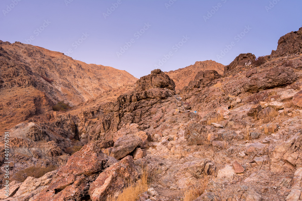Barren mountain in Darband valley in dawn against purple sky in the Tochal mountain. A popular recreational region for Tehran's residents