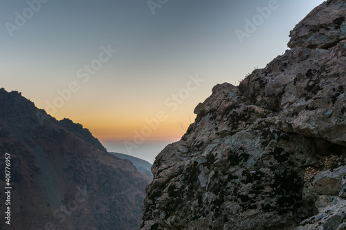 Barren mountain in Darband valley in dawn against colorful sky in the Tochal mountain with background of Tehran city in the morning. A popular recreational region for Tehran s residents