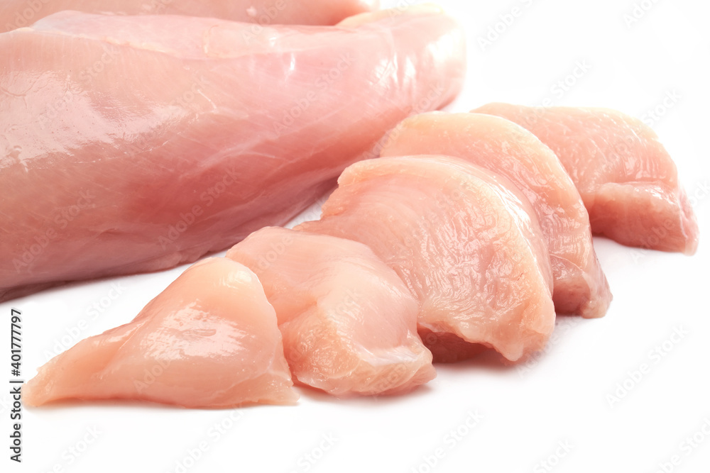 Fresh raw chicken breast fillet whole and sliced isolated closeup on white background, clipping path Fresh raw chicken breast fillet whole and sliced isolated closeup on white background, clipping path