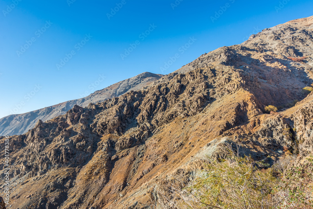 Barren mountain in Darband valley in autumn in the morning against blue sky in the Tochal mountain. A popular recreational region for Tehran's residents Barren mountain in Darband valley in autumn in the morning against blue sky in the Tochal mountain. A popular recreational region for Tehran's residents