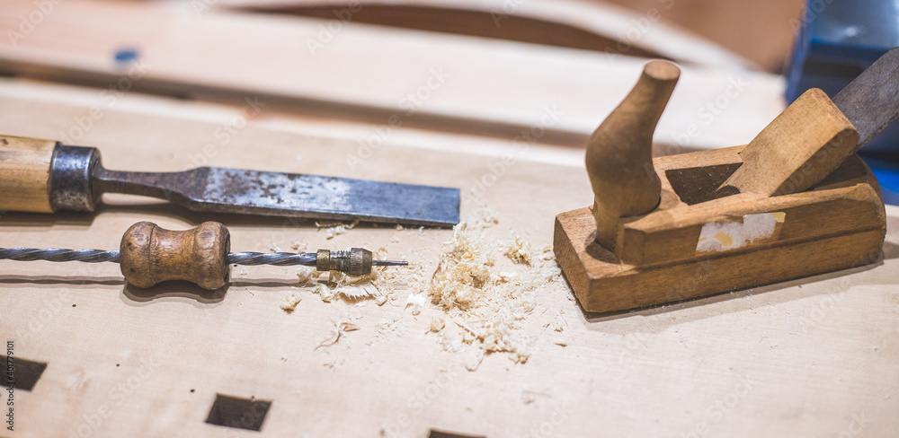 Home handyman using a plane for smoothing down a piece of timber Home handyman using a plane for smoothing down a piece of timber