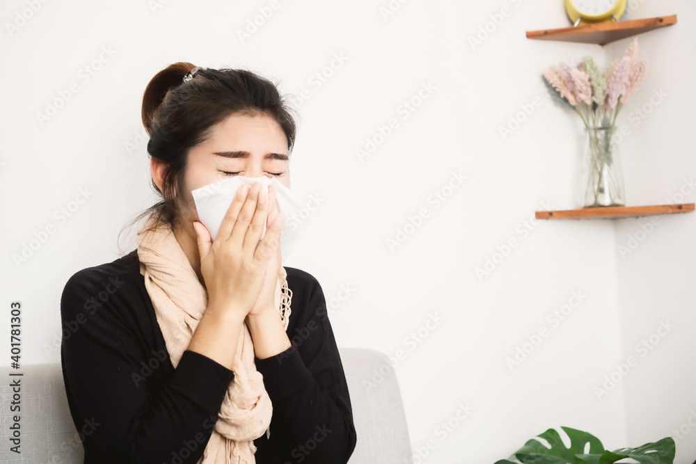 illness Asian woman sneezing hand holding tissue paper covering her runny nose illness Asian woman sneezing hand holding tissue paper covering her runny nose