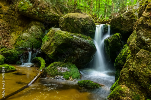 Fototapeta Naklejka Na Ścianę i Meble -  nice waterfall with huge rocks with green moss in a forest