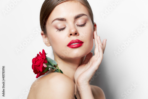 Woman with rose With closed eyes  holds a hand near the face cute face 