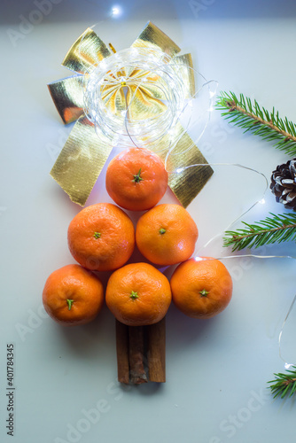 tangerines on a white background with a Christmas tree