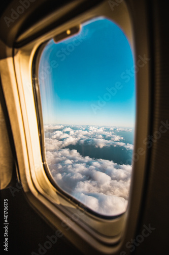 Clouds and sky as seen through window of in airplane
