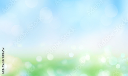 Green grass blue sky blurred bokeh background.Abstract spring summer nature backdrop.Natural texture.