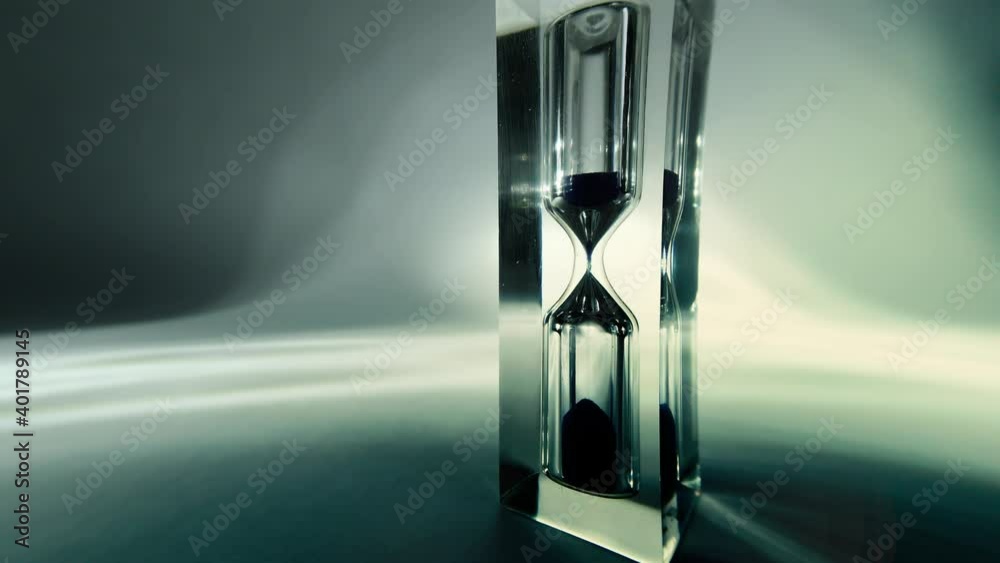 Time lapse macro video of modern hourglass with beautiful gradient, sandglass close-up. Sand texture, falling sand. Old retro grunge vintage style.