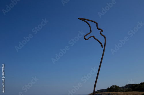 Iron bird for garden decor on blu sky