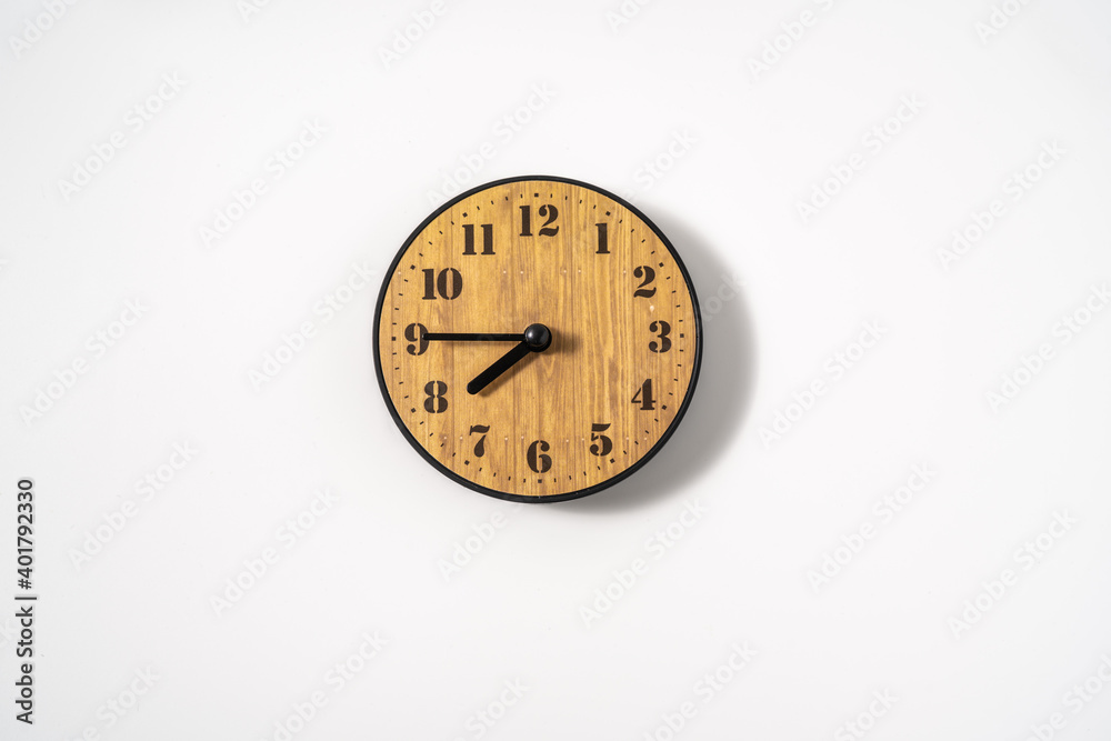 wood office wall clock with white dial on white background. wall clock on white background, top view. wood office wall clock with white dial on white background. wall clock on white background, top view.