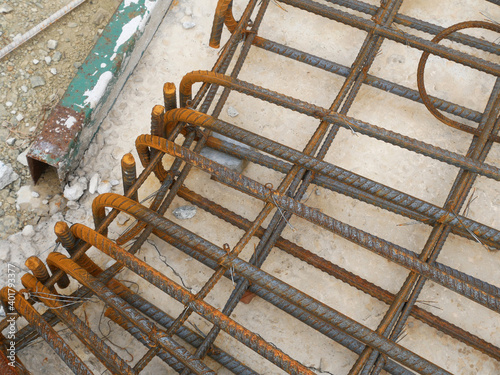 SEREMBAN, MALAYSIA -MARCH 29, 2020: Construction workers fabricating steel reinforcement bar at the construction site. They tied it together using the tiny wires before cover it up using formworks. 