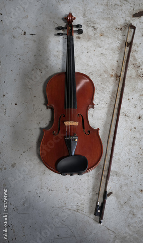 Violin and bow put on grunge surface background © Watcharin