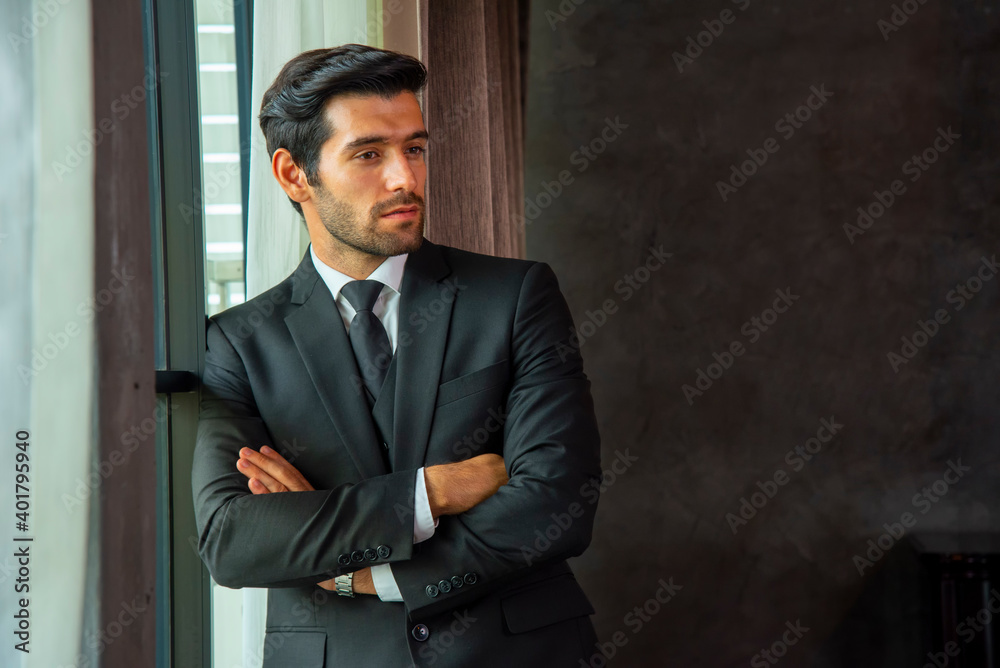 A handsome business man with his arms folded thinking to do his job. A handsome business man with his arms folded thinking to do his job.