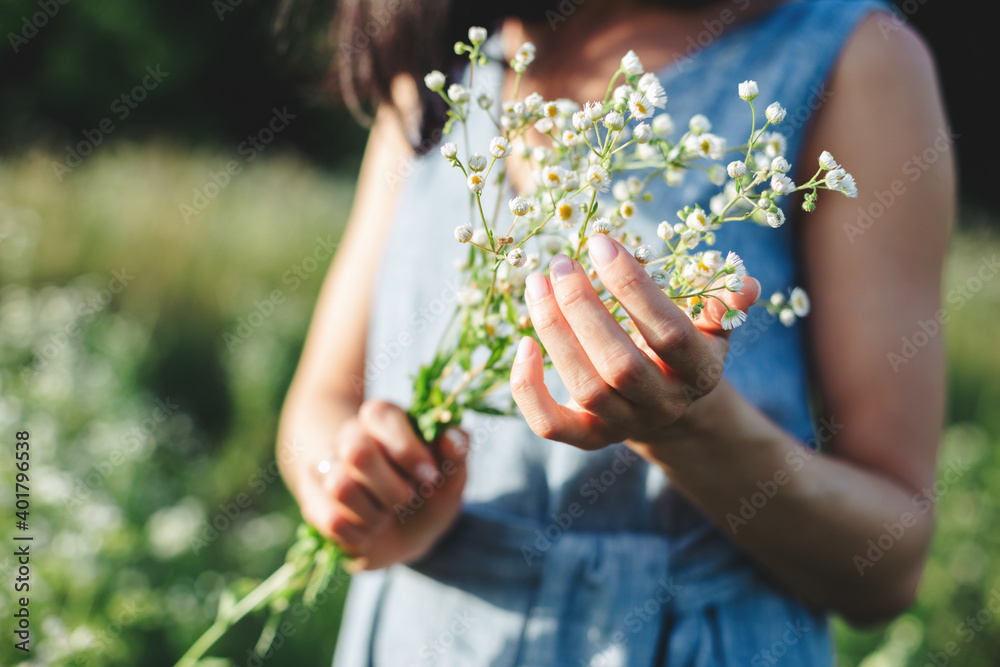 Beautiful girl with a bouquet of wildflowers on a meadow in sunlight. Beautiful girl with a bouquet of wildflowers on a meadow in sunlight.