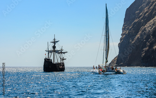 Replica of the historic ship of Christopher Columbus Santa Maria and a pleasure catamaran off the coast of Madeira. photo