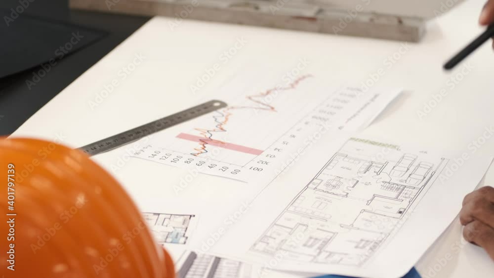 looking at the graph to see the result business pen plan paper finance drawing document calculator blueprint architecture construction pencil architect financial chart data graph project design office